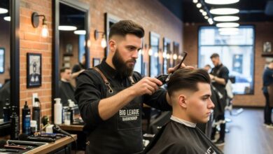 Professional barber applying precise fade haircut technique at modern big league barbershop