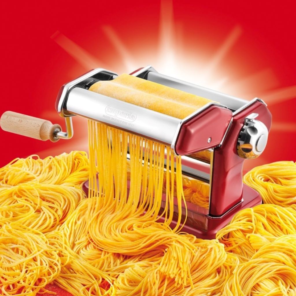 Hands preparing thin, delicate pasta using the Imperia angel hair cutter.