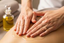 Therapist applying massage oil during a spa session