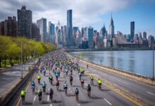 Thousands of cyclists riding along the FDR Drive during the NYC Five Boro Bike Tour with Manhattan skyline in background