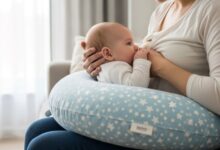 Nursing pillow supporting baby during feeding session with proper positioning