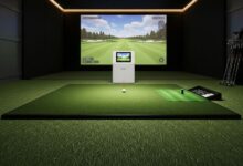 Golf hitting mat with realistic turf surface positioned under launch monitor in home simulator setup