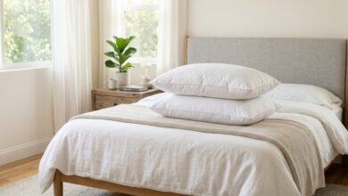 Plush white down pillow stacked on a supportive feather pillow on a cozy bed.